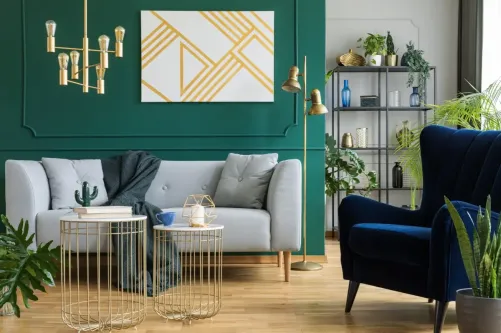 Colour Consultation Living Room with Green Accent Wall Stylish living room with deep green feature wall, gold lighting accents and soft neutral furniture, showing balanced colour consultation for modern interiors.